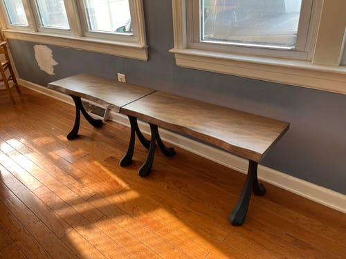 Customer's completed long wooden bench using the black Xeni bench legs on a hardwood floor.