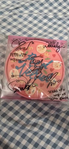 Customer's signed Red Velvet 'Birthday' album in its pink, circular case, viewed through the autographed plastic wrap.