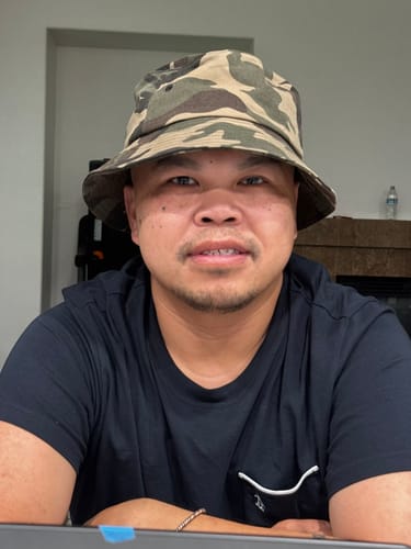 Reviewer looking forward while wearing the Big Standard Bucket Hat in a camouflage pattern.