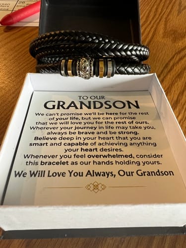 Customer's 'To My Grandson' braided leather bracelet and message card inside the open gift box.