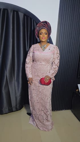 Reviewer in a pink lace dress wearing the Silver Flower Shape Necklace at a wedding party.