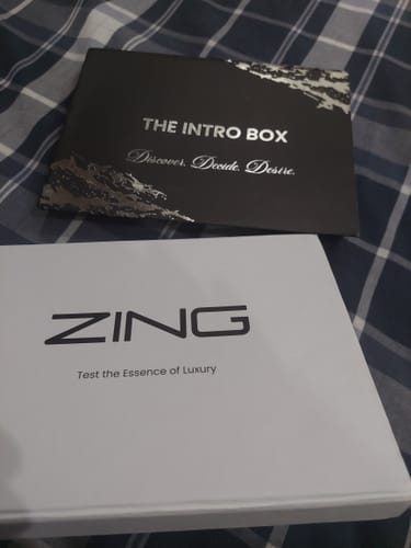 Customer's packaging for the Female Tester Pack, showing the white box and black intro card laid on a plaid surface.