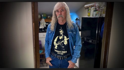 Customer wearing the black Lincoln 250 T-Shirt styled with an open denim jacket and jeans.