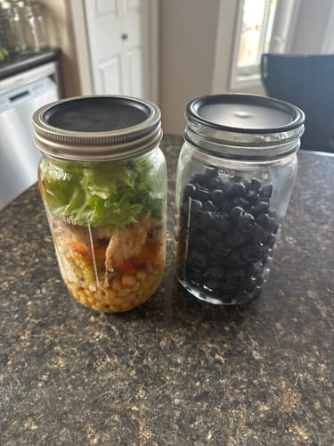 Customer's fresh salad and blueberries in two mason jars after being sealed with the Mason Genie Vacuum Sealer.