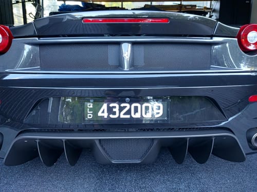 Customer's Rear Modular Base Plate installed on the back of a dark sports car, giving the license plate a clean, floating look.