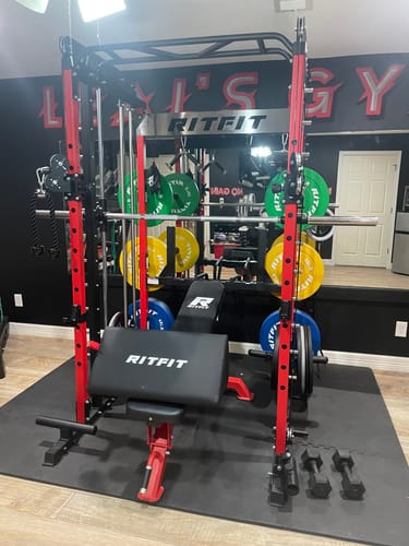 Customer's RitFit Preacher Curl Pad attached to a bench in a home gym with other equipment.