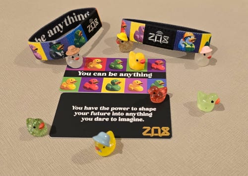Customer's 'You Can Be Anything' bracelets, matching cards, and small themed duck figures displayed together.