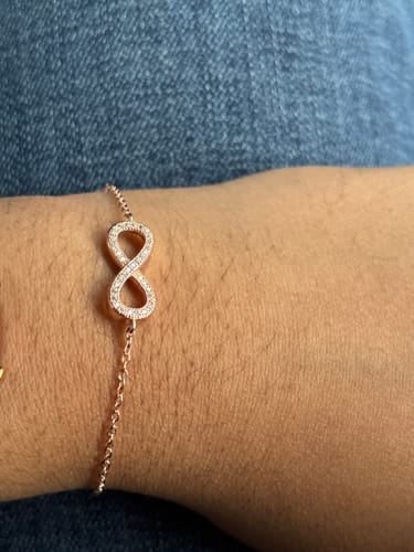 Customer wearing the Rose Gold Forever You Bracelet on their wrist, showing the zircon-studded infinity motif.