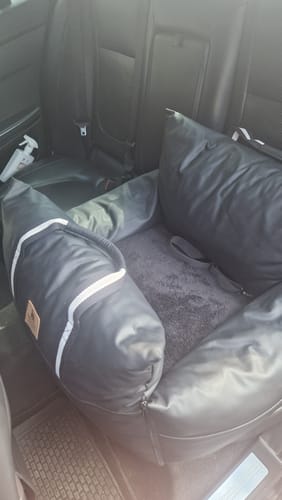 Customer's black Dog Dock V2 installed in the back seat of a car, showing its plush grey interior.