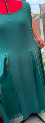 Customer shows green Georgette fabric used to add vents to a flowing dress on a red dress form.