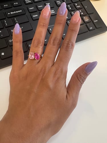Reviewer showing their Toi Et Moi Birthstone Ring with two different pink stones on their hand.
