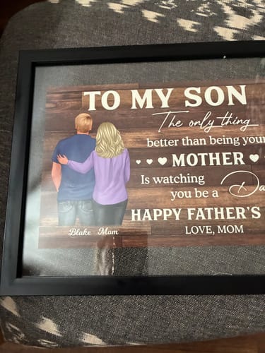 Customer's personalized 'To My Son' poster displayed in a black frame, showing a mother and son illustration.