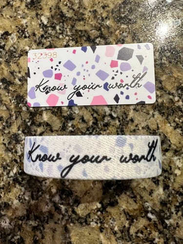Customer's Know Your Worth Bracelet and matching patterned card laid out on a countertop.