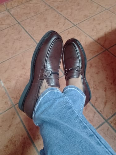 A reviewer wearing the brown Lufiano Slip On shoes with blue jeans, seen from a top-down perspective.