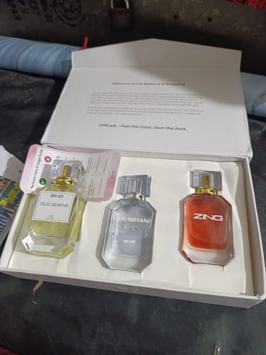 Customer's OUD Supreme BUNDLE with the three perfume bottles, Oud Serene, Oud Nirvana, and ZING, displayed in their open white box.
