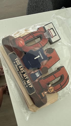 Customer shows a basketball-themed Father's Day plaque that arrived safely thanks to Shipping Protection.