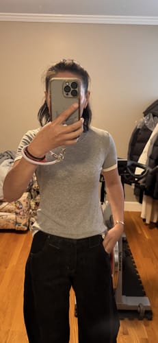 Customer taking a mirror selfie wearing the Lyocell Wool Blend Contrast T Shirt, showing the fit and white trim on the neck.