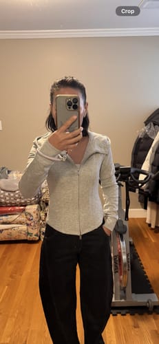 Reviewer in a mirror selfie wearing the light grey Cotton Full Zip Sweatshirt, fully zipped.