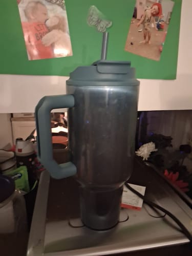 Customer's Thicc Buddy 50oz tumbler in Opal Sky shown with its lid and straw on a countertop.