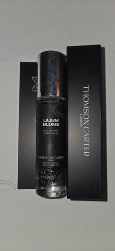 Customer's small Lilium Blume perfume bottle shown next to its sleek black packaging.