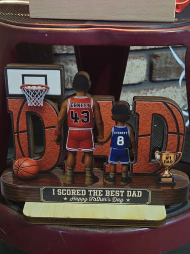 Customer's personalized basketball-themed wooden plaque showing figures of a father and son with custom names and numbers.