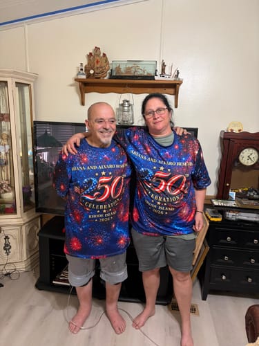 Two reviewers wearing their matching custom patriotic 250th Anniversary shirts in a living room.