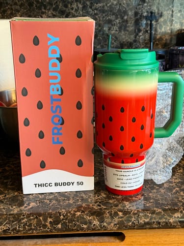 Customer's Thicc Buddy 50oz mug in a watermelon design, displayed on a counter next to its original box.