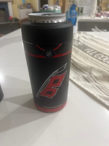 Customer's black Universal Buddy can cooler with the Carolina Hurricanes logo, holding a can on a table.