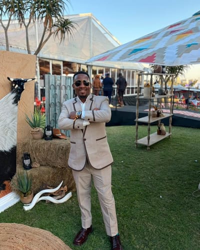 Customer standing outdoors wearing burgundy Lufiano Lace up shoes with a tan suit.