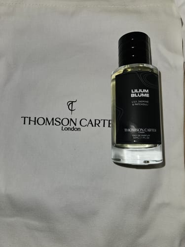 Customer's Lilium Blume perfume bottle on top of a branded cream-colored fabric bag.
