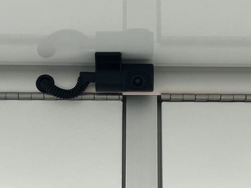 Customer's camera mounted to the white metal ceiling of an enclosed trailer.