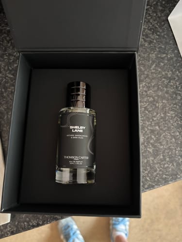 Customer's Shelby Lane eau de parfum glass bottle nestled in a sleek black gift box.