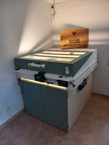 Customer's Atomstack laser engraver, used with Lightburn software, inside a large, custom-built green enclosure.