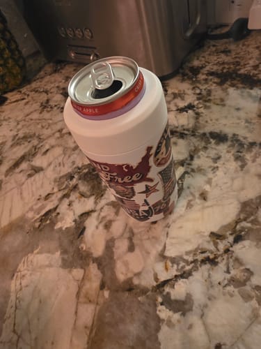 Customer's patterned Universal Buddy can cooler sitting on a marble countertop holding a beverage can.