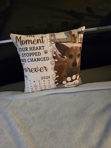 Customer's memorial pillow featuring a photo of Sparky the dog, sitting on a bed with a light blue blanket.