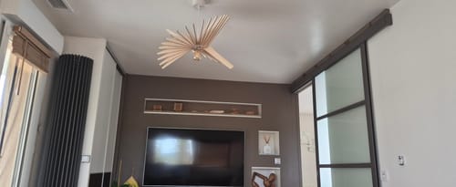 Customer's Albatros suspension lamp made of wooden slats hanging from the living room ceiling