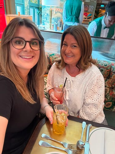 Customer's photo of a person during a celebratory lunch, enjoying the experience associated with Lilium Blume fragrance.