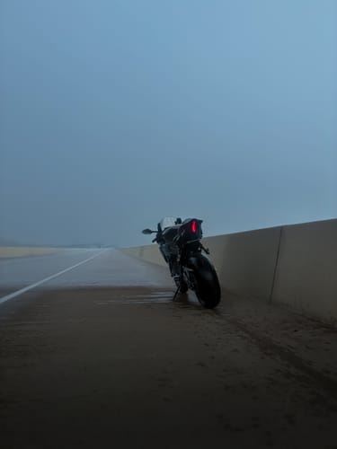 Customer's Yamaha R7 motorcycle parked on a wet, misty road with a sleek tail tidy installed.