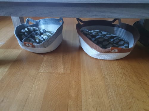 Customer's two Instinct Baskets with soft liners sitting on a wood floor under a table.