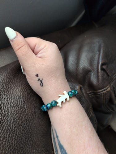 Customer's Shark Week Bracelet featuring blue marble-style beads and a hammerhead charm worn on their wrist.