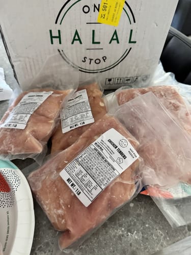 Customer's order of several vacuum-sealed packages of fresh chicken next to the delivery box.