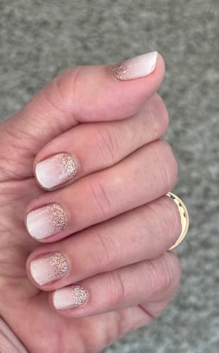 Reviewer's hand showing UV Gel Babyboomer Nude Sparkle nail wraps with a natural gradient and delicate glitter finish.