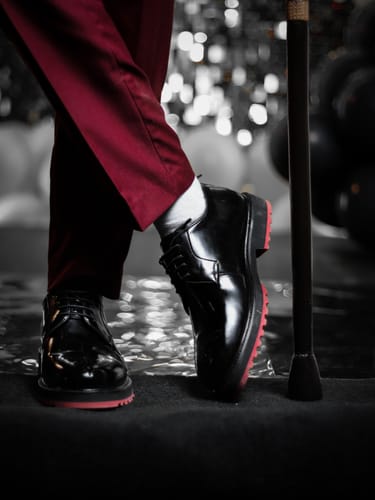 Customer's Lufiano Lace up shoes, showing the black leather and distinct red soles.