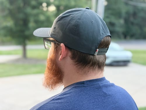 Customer's grey Big Lightweight Nylon Hat, back view showing the adjustable rear strap