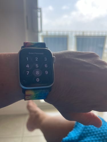 Customer's colorful The Best You Is The Real You watch band worn on their wrist, showing the watch face.