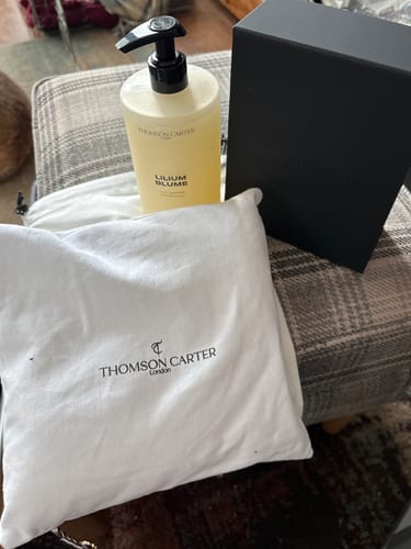 Reviewer's photo of the packaging for their Smoke & Mirrors perfume, including a black box and a white branded bag.