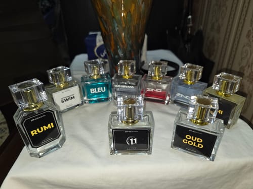 Customer displays their large perfume collection, including bottles from the Summer Box, on a white cloth.