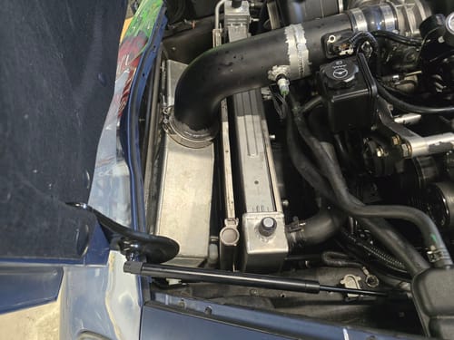 Customer's RIFE IAT sensor installed on a black intake tube inside a car's engine bay.