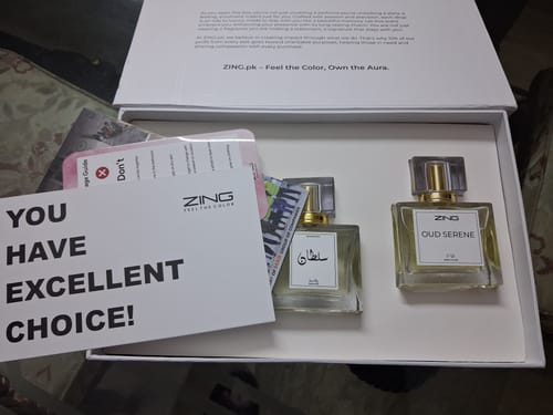 Reviewer's OUD Supreme BUNDLE showing two glass perfume bottles, including Oud Serene, in the original white presentation box.