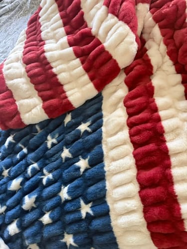 Customer's close-up of the soft, plush Hugs Flag Blanket showing the American flag pattern.